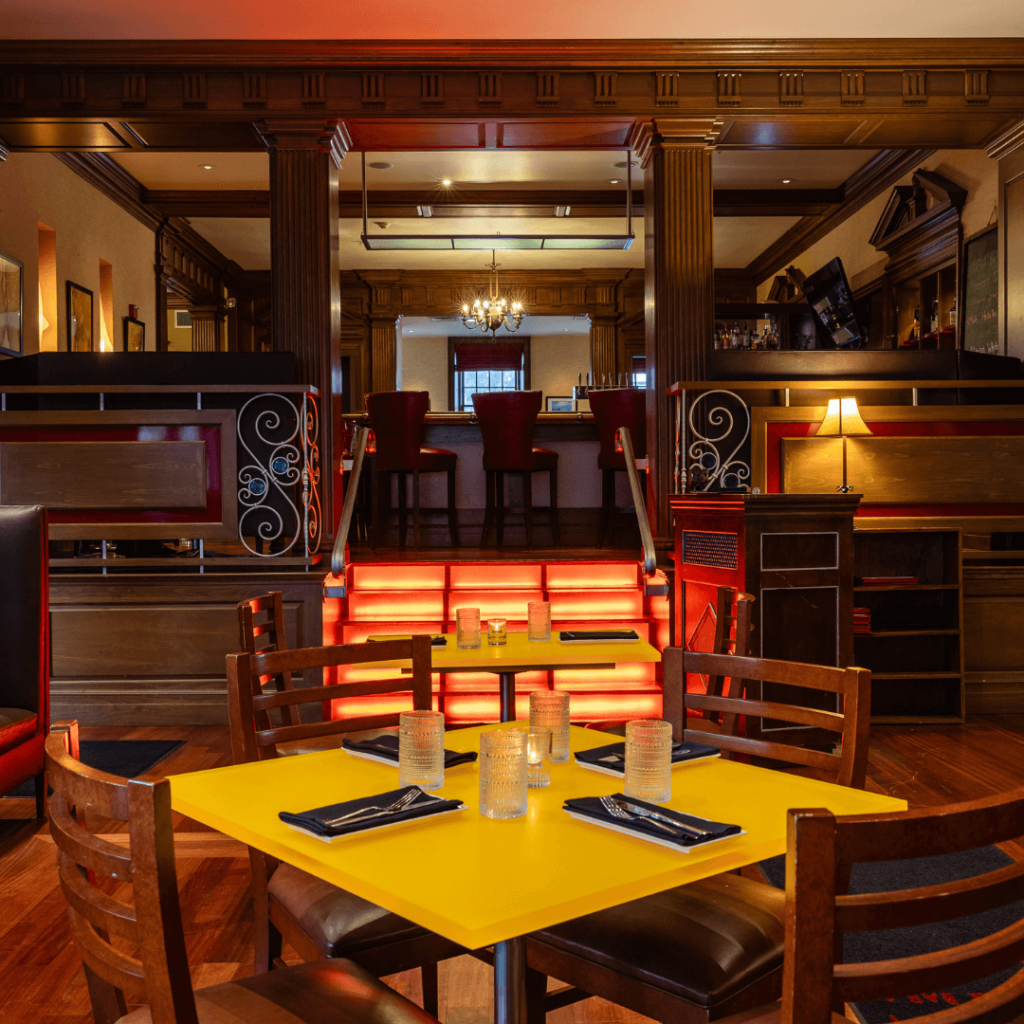 Well lit dinning room with a table set for two